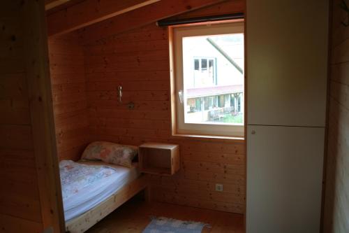 a small room with a bed and a window at RechHof Urlaub mit Tieren in Schalkenbach