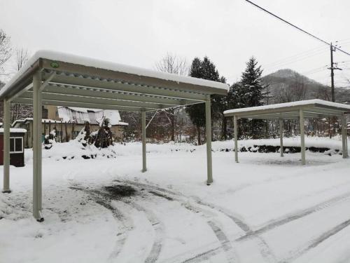 a bus stop covered in snow in front at MolinHotels201温泉付き別荘 -アクティビティを満喫できる札幌定山渓-2LDK W-beds2&S-beds4 in Jozankei
