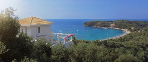 a building with a view of a beach and the ocean at LIVINGHOME SUITES in Parga