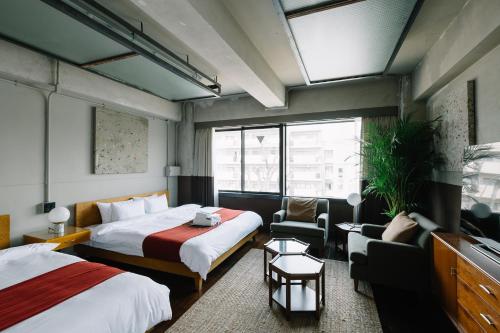 a hotel room with two beds and a window at HOTEL Inc in Kyoto