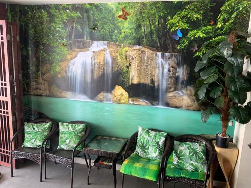 a room with a waterfall mural on the wall at Ban Por Fai in Cha Am