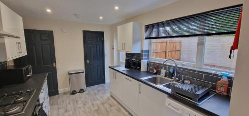 a kitchen with a sink and a window in it at Shirley L, Milton, Cambridge, 4 BR House, Newly Refurbished in Milton