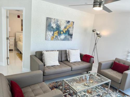ein Wohnzimmer mit einer Couch und einem Glastisch in der Unterkunft Direct Ocean View - Luxurious condo in South Beach in Miami Beach