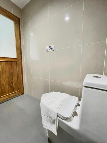 a bathroom with a toilet with a towel on it at Alleyhill Phuket - Private & Cozy Boutique in Phuket Town