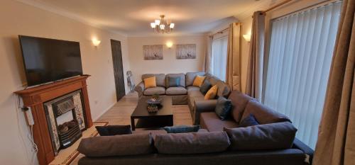 a living room with a couch and a television at Shirley L, Milton, Cambridge, 4 BR House, Newly Refurbished in Milton