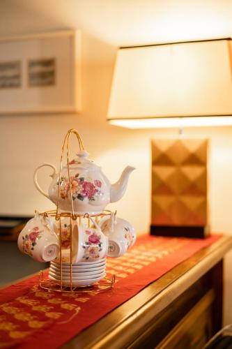 a tea set on a table with plates and a teapot at Hotel Penaga in George Town