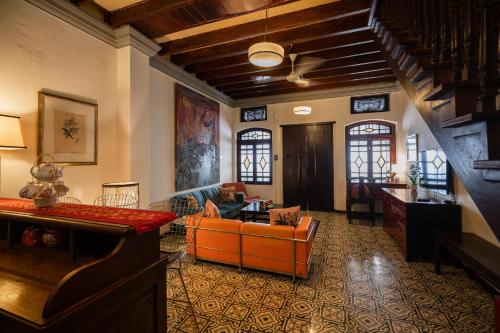 a living room with a couch and a table at Hotel Penaga in George Town