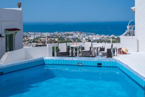 a swimming pool on the roof of a house at Private Studio Korifi sea view in Hersonissos