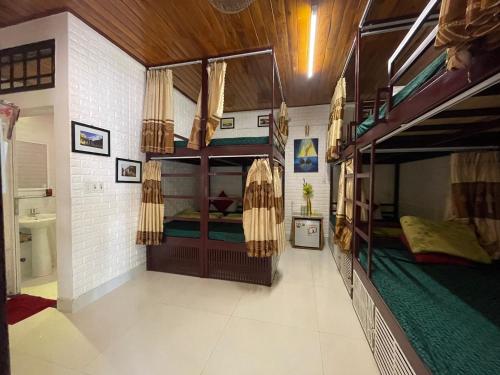 a room with two bunk beds in a house at Red House Homestay - Villa in Hoi An