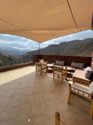 a large room with a view of the mountains at Issouganes N Toubkal Maison d hôtes in Oussertek