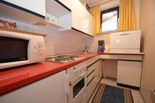 a kitchen with a microwave and a stove at Studio 13 - by Four Seasons Apartments in Kaprun