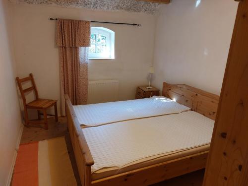 a bedroom with two bunk beds and a chair at Fewo Leezdorf in Leezdorf