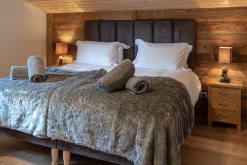 une chambre avec un grand lit avec deux serviettes dessus dans l'établissement Apartment La Colombe, aux Gets