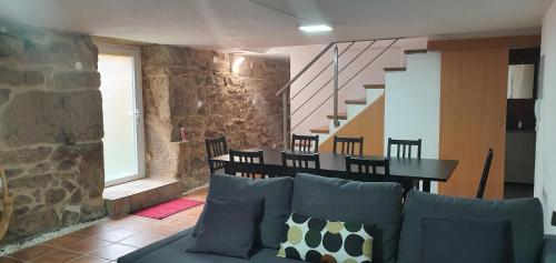a living room with a couch and a table and stairs at Casa Pinto - AL in Valença