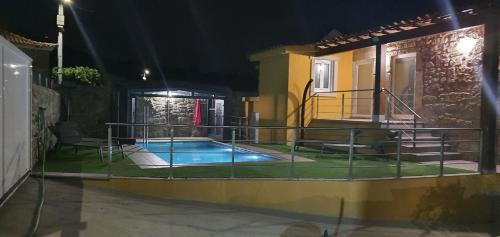 a house with a swimming pool at night at Casa Pinto - AL in Valença