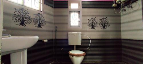 a bathroom with a sink and a toilet in it at Hotel Orchid in Kalimpong