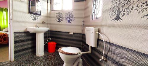 a bathroom with a toilet and a sink at Hotel Orchid in Kalimpong