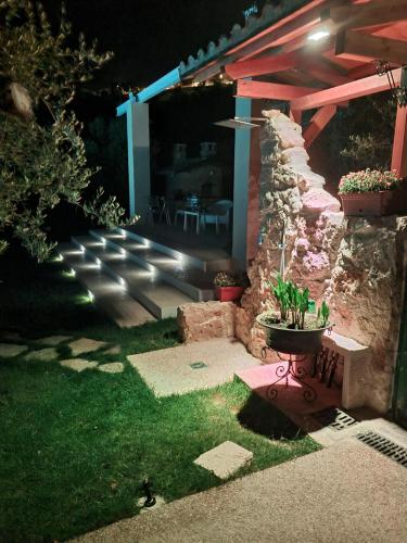 a garden at night with a table and a patio at Rocky House in Ripa Teatina