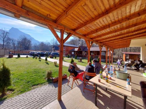 a group of people sitting at a table on a patio at Cabana Sweetlife in Rimetea
