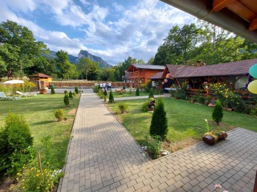 a garden with a brick pathway and a building at Cabana Sweetlife in Rimetea