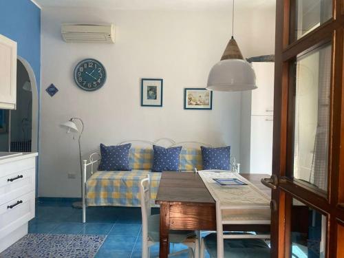 a living room with a table and a couch at I datteri Bilocale ristrutturato a meno di 300 mt dal mare in Gaeta
