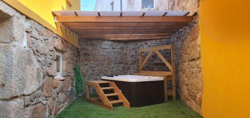 a bathroom with a sink in a stone wall at Casa Pinto - AL in Valença