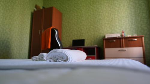 a hotel room with a bed with towels on it at Colchis ca777 in Kutaisi