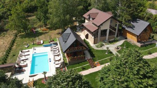 an aerial view of a house with a swimming pool at Apartmani Joka i Drvene kucice in Vrdnik