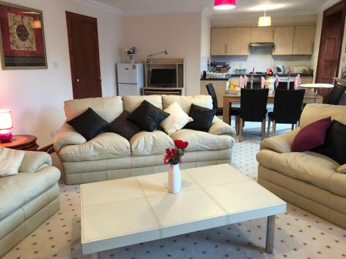 a living room with a couch and a coffee table at Executive Serviced Apartments 1 in Forfar