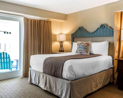 a large bed in a hotel room with a large window at Bluegreen Vacations The Soundings in Dennis Port