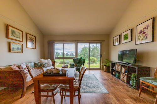 a living room with a couch and a table at Meander Retreat - The Green Room in Springton