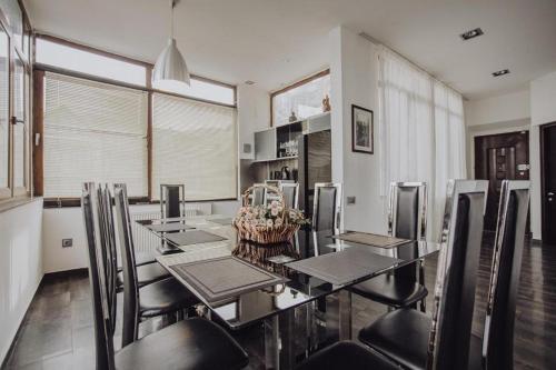 a dining room with a long table and chairs at Millennium Tbilisi in Tbilisi City