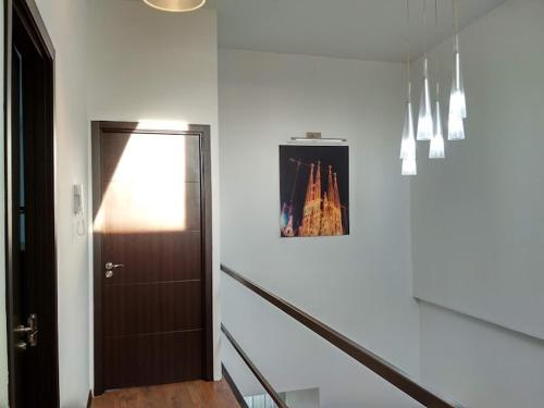 a hallway with a door and a picture on the wall at Millennium Tbilisi in Tbilisi City