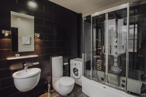 a bathroom with a toilet sink and a shower at Millennium Tbilisi in Tbilisi City