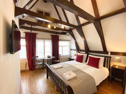 a bedroom with a large bed with red pillows at Flinder Amsterdam in Amsterdam