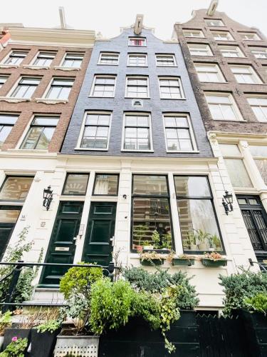a building with windows and plants in front of it at Flinder Amsterdam in Amsterdam