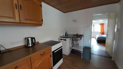a kitchen with a sink and a stove top oven at Gemütliche Ferienwohnung im Fachwerkhaus, 1 Schlafzimmer, Balkon, Parkplatz -1 in Wolfhagen
