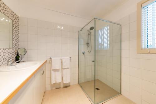 a bathroom with a shower and a sink at Meander Retreat - Garden Studio in Springton