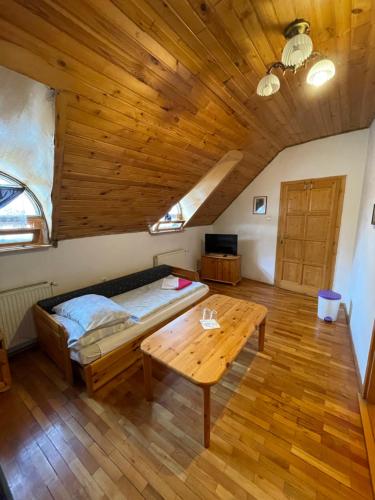 a small room with a wooden floor and wooden furniture at Katalinkert Panzió in Győr