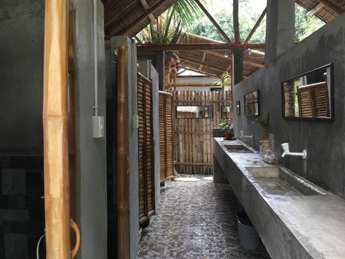 a hallway of a house with two sinks in it at La Tortue Diving Resort Dauin in Dauin