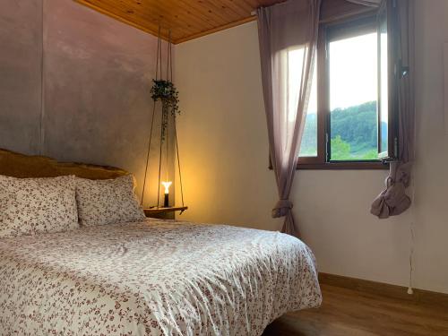 A bed or beds in a room at Finca La Naguada Casa Rural en Asturias
