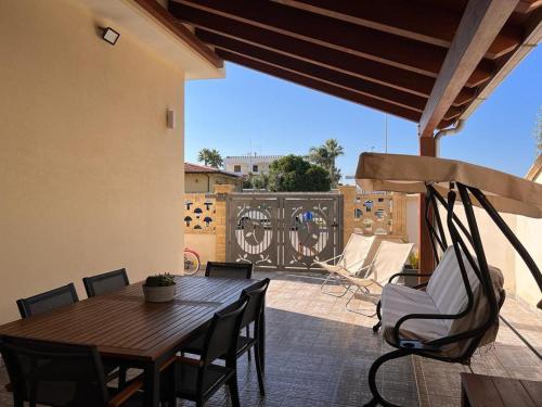 a wooden table and chairs on a patio at Casa BeFra Il relax che cercavi in Torre San Gennaro