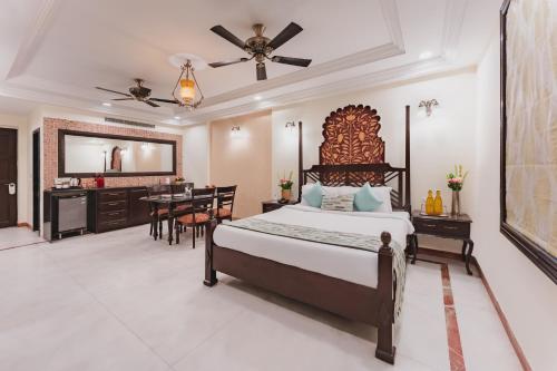 a bedroom with a bed and a dining room at Shree Vallabh Vilas Lords Plaza in Eklingji