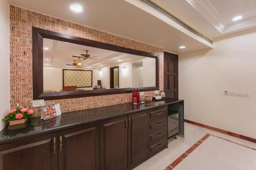 a bathroom with a large mirror and a sink at Shree Vallabh Vilas Lords Plaza Nathdwara - Pure Veg in Eklingji