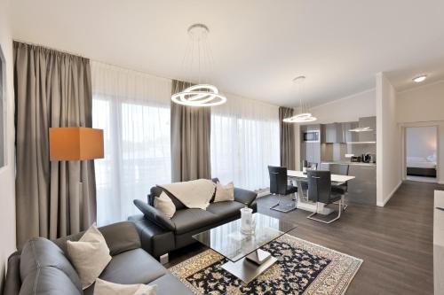 a living room with a couch and a table at Aquamaris Strandresidenz Rügen in Juliusruh