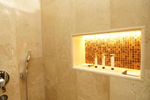 a bathroom with a shower with a light on the wall at Villa Bali Jeddah in Jeddah