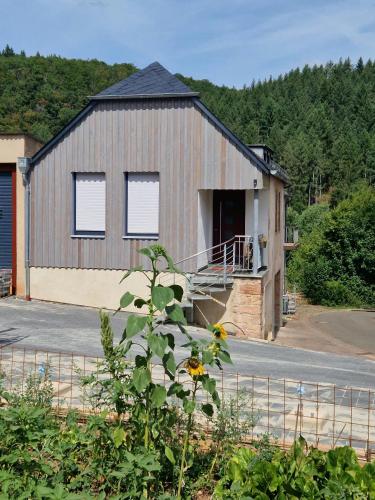 a large building with a garage with a porch at Meyer Holiday in Heckenmünster