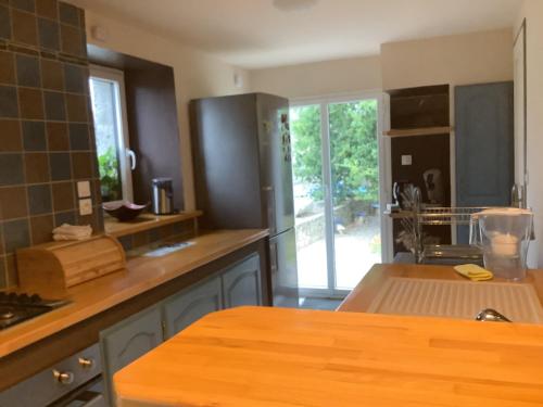 a kitchen with a wooden counter top in a room at La petite maison terre mer in Plélo