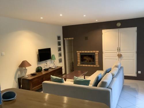 un salon avec un canapé et une table dans l'établissement La petite maison terre mer, à Plélo