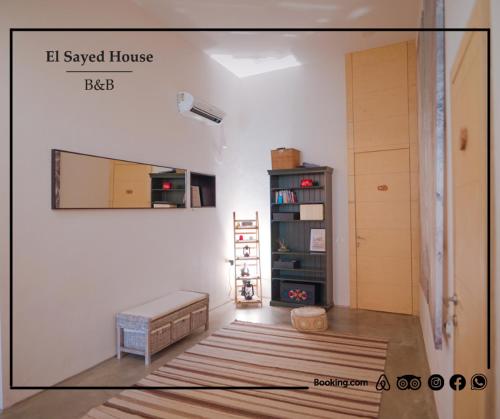 a living room with a bed and a book shelf at El Sayed House in ‘Akko